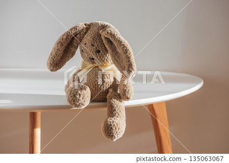 Lonely Plush Bunny on Minimal Table in Soft Light Lonely Plush Bunny on Minimal Table in Soft Light 135063067