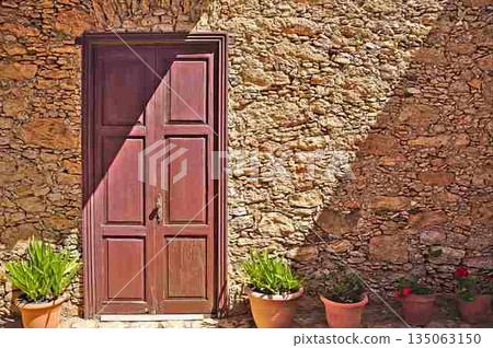 Old door on a historic building with flowers in front 135063150