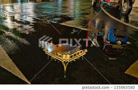 Golden Mount reflection in a puddle and a Tuk Tuk 135063580