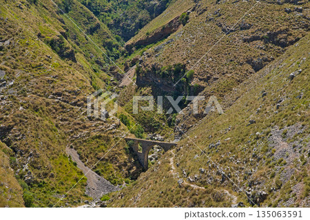 View of a serene and tranquil mountain valley at the Ali Pasha bridge View of a serene and tranquil mountain valley at the Ali Pasha bridge 135063591