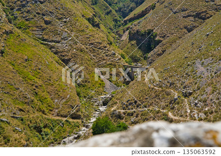 View of a serene and tranquil mountain valley at the Ali Pasha bridge 135063592