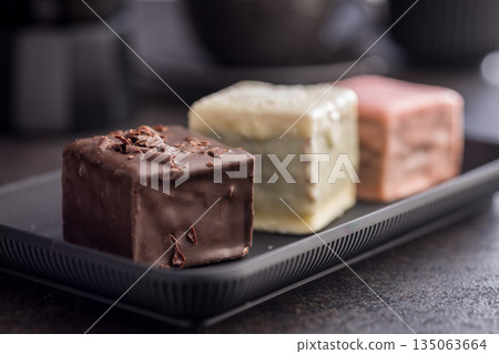 Sweet dessert cake. Mini pie on plate on black table. 135063664