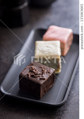 Sweet dessert cake. Mini pie on plate on black table. Sweet dessert cake. Mini pie on plate on black table. 135063665