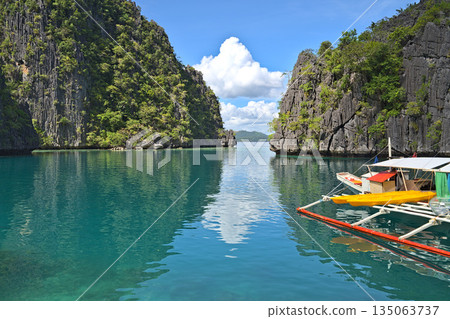 Coron Island Lagoon wita h tourist boat at the pier Coron Island Lagoon wita h tourist boat at the pier 135063737