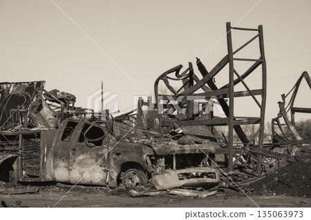 Destruction of vehicle and structure after fire at industrial site in morning light Destruction of vehicle and structure after fire at industrial site in morning light 135063973