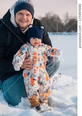 Father and Baby Enjoying Snowy Day Together Father and Baby Enjoying Snowy Day Together 135064086