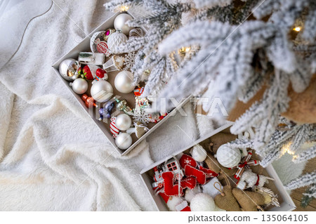 Christmas Ornaments Under Snow-Covered Tree Christmas Ornaments Under Snow-Covered Tree 135064105
