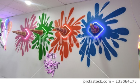 Colorful ice cream cone wall art with neon lights and vibrant splashes, creating a playful atmosphere for a sweet day celebration Colorful ice cream cone wall art with neon lights and vibrant splashes, creating a playful atmosphere for a sweet day celebration 135064173
