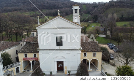 Aerial view of the historic Santa Maria Assunta Church, known as La Rotonda, in Rezzato, Italy. Ancient Romanesque architecture in the Valverde valley, Brescia province. 135065095