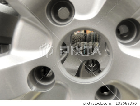 Central Hole Of Alloy Wheel Rim On The Shelf Of Car Parts Store 135065350
