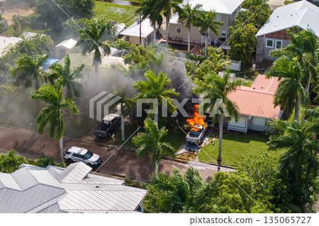 Emergency service personnel responding to car accident on Florida street. First responders extinguishing fire on burning vehicle 135065727
