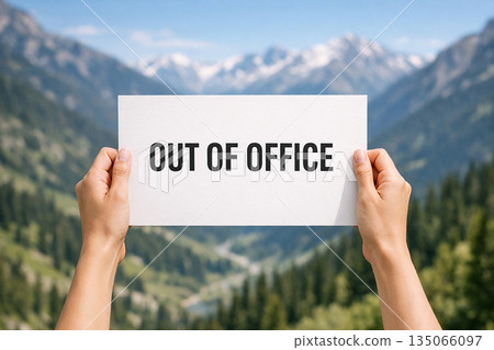 Out of office on white banner with two hand holding the banner. 135066097