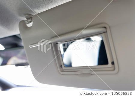 Close-up of the mirror on the car's sun visor. 135066838