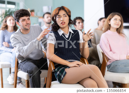 Students sit attentively in the classroom and listen to lectures 135066854