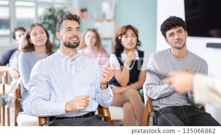 Young guy commenting during lesson in modern classroom 135066862