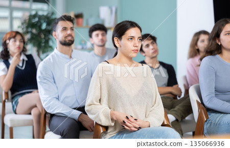 Young girl listening during seminar in a modern classroom 135066936