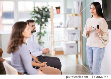 Female teacher giving a presentation in front of the class Female teacher giving a presentation in front of the class 135066943