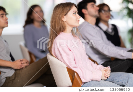 Students sit attentively in the classroom and listen to lectures 135066950