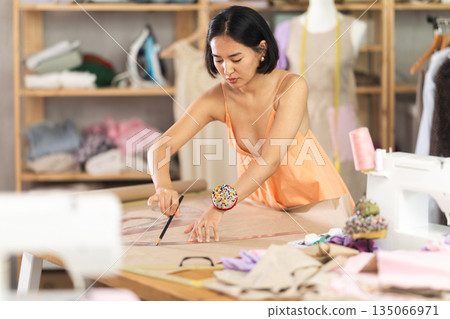 Girl seamstress to draw using patterns Girl seamstress to draw using patterns 135066971
