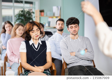 Students sit with their eyes closed, meditation Students sit with their eyes closed, meditation 135067009