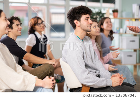 Group of happy students laughing during educational class Group of happy students laughing during educational class 135067043
