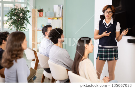Female teacher giving a presentation in front of the class 135067053