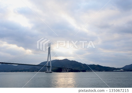 Tatara Bridge overlooking Omishima from Ikuchijima. A view of the Shimanami Kaido. Tatara Bridge overlooking Omishima from Ikuchijima. A view of the Shimanami Kaido. 135067215