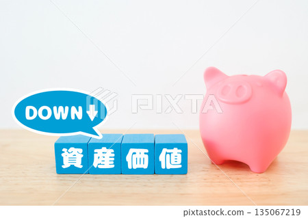 A piggy bank and downward image showing a decline in asset value. A piggy bank and downward image showing a decline in asset value. 135067219