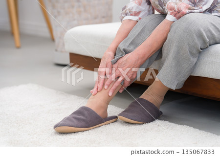 An elderly woman in her 80s with ankle pain An elderly woman in her 80s with ankle pain 135067833