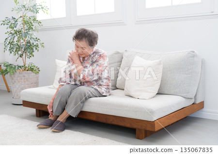 A woman in her 80s with stiff shoulders A woman in her 80s with stiff shoulders 135067835