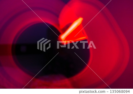 Abstract red light painting shape on dark Abstract red light painting shape on dark 135068094