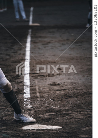 A young baseball player batting in a baseball game A young baseball player batting in a baseball game 135068103