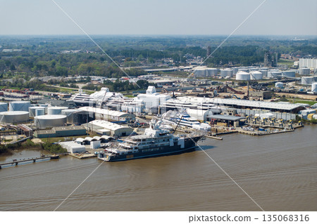 Commercial shipyard dock for luxury sea yachts manufacturing. Construction and assembling of deep water ships Commercial shipyard dock for luxury sea yachts manufacturing. Construction and assembling of deep water ships 135068316