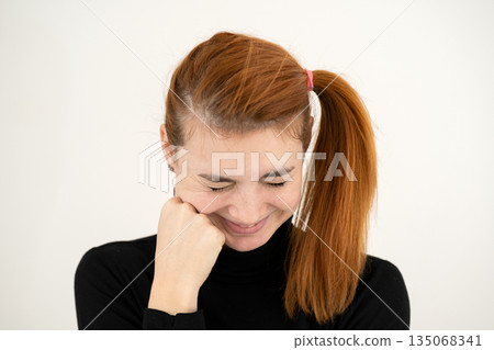Closeup portrait of a funny redhead teenage girl with childish hairstyle isolated on white backround. Closeup portrait of a funny redhead teenage girl with childish hairstyle isolated on white backround. 135068341
