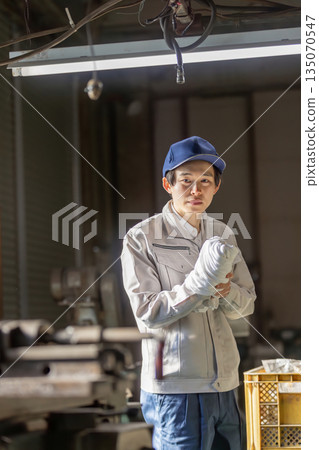 Male worker injured at factory Male worker injured at factory 135070547