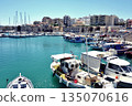 A view of the harbor of Heraklion, Crete, Greece, with ships in the foreground and the cityscape in the background 135070616