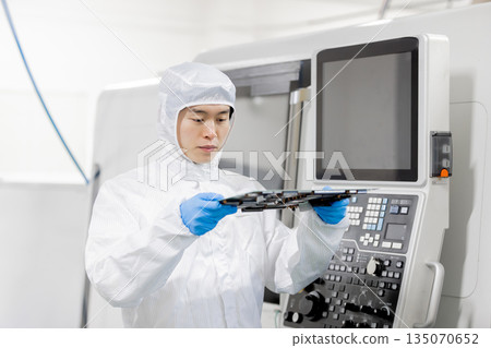 Workers inspecting products in a factory 135070652