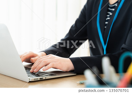 Hands of a woman working on a laptop 135070701