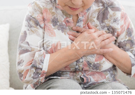 Image of a senior woman in poor health, concerned about heart and chest pain. Myocardial infarction...? Intercostal neuralgia? No face Image of a senior woman in poor health, concerned about heart and chest pain. Myocardial infarction...? Intercostal neuralgia? No face 135071476