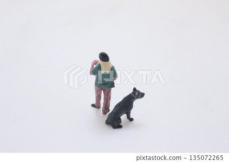Miniature Man With Dog Figurine On White Background 135072265