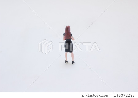 Miniature Woman In Black Dress Stands With Hands 135072283