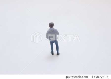 Miniature Man Figurine In Gray Jacket Standing Thoughtful Miniature Man Figurine In Gray Jacket Standing Thoughtful 135072303