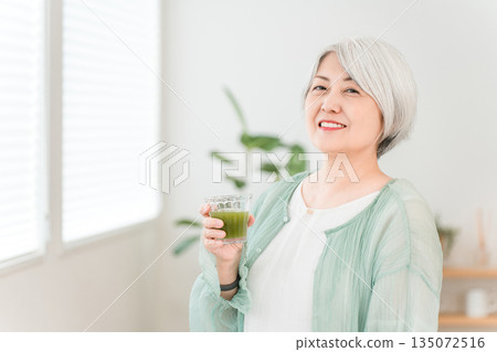 Senior women drinking green juice, green smoothies, and vegetable juice for health Senior women drinking green juice, green smoothies, and vegetable juice for health 135072516