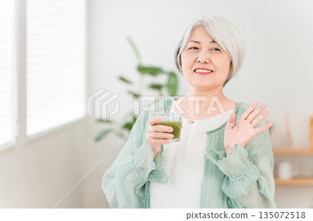 Senior women drinking green juice, green smoothies, and vegetable juice for health 135072518
