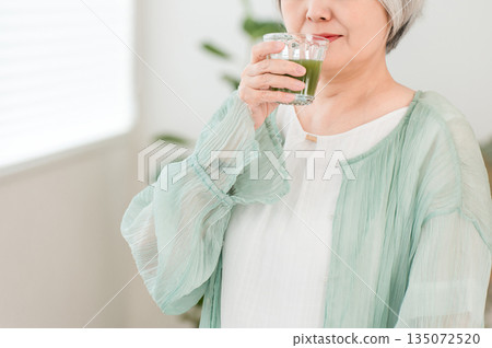 Senior women drinking green juice, green smoothies, and vegetable juice for health 135072520