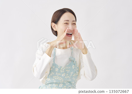 Woman wearing an apron cheering white background facing right 135072667