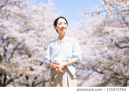 Young woman stretching under a cherry tree Lifestyle image Young woman stretching under a cherry tree Lifestyle image 135072769
