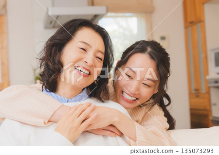 A close relationship between unmarried daughter and mother A close relationship between unmarried daughter and mother 135073293