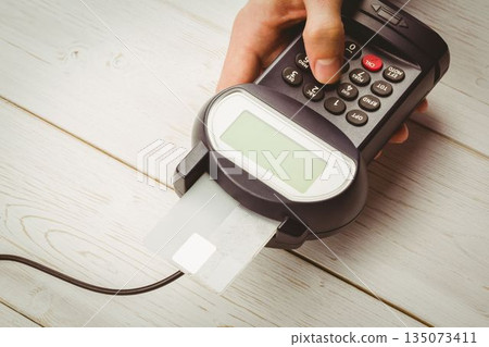 Man paying with credit card Man paying with credit card 135073411
