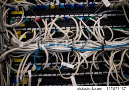 Network patch panel is being shown with tangled Ethernet cables and RJ45 connectors in flat design Network patch panel is being shown with tangled Ethernet cables and RJ45 connectors in flat design 135073487
